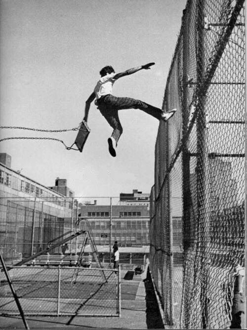 A child jumping off a swing