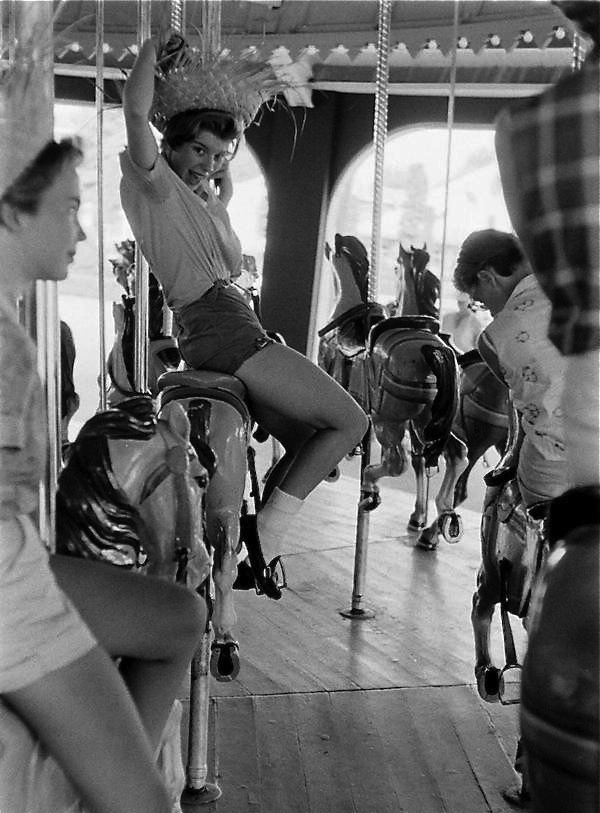 Girl on a merry go round at Coney Island, 1963